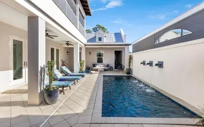 a swimming pool in the backyard of a house at Winters End by Oversee 30A in Santa Rosa Beach