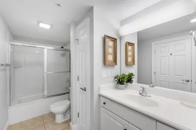 a white bathroom with a sink and a toilet at Treasure Island #2302 in Panama City Beach