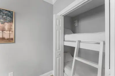 a room with a bunk bed and a closet at Treasure Island #2302 in Panama City Beach