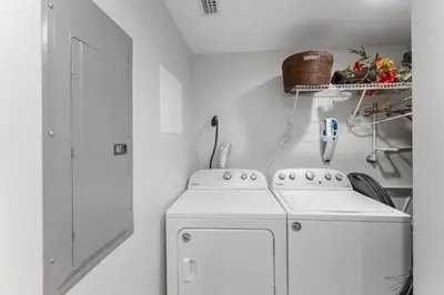 a kitchen with a white stove and a washer at Treasure Island #2302 in Panama City Beach