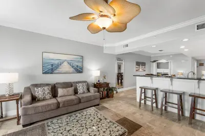 a living room with a couch and a bar at Treasure Island #2302 in Panama City Beach