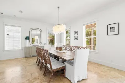 a dining room with a table and chairs at Steps to Beach, Large Private Pool, Bikes, Luxury in Santa Rosa Beach