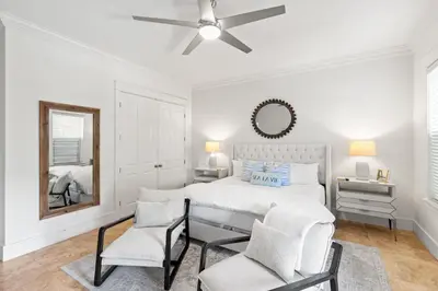 a white bedroom with a bed and a mirror at Steps to Beach, Large Private Pool, Bikes, Luxury in Santa Rosa Beach