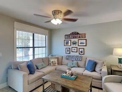 a living room with a couch and a table at Villa Chateau #10 in Panama City Beach
