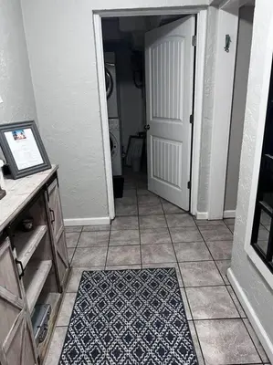 a hallway with a white door and a tile floor at 3 Bdrm Condo- 4 pools, hot tub & walk to Beach in Panama City Beach