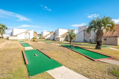 a group of miniature golf courses in a yard at 3 Bdrm Condo- 4 pools, hot tub & walk to Beach in Panama City Beach