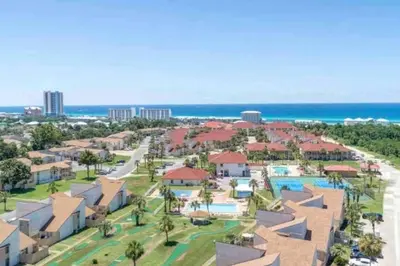 an aerial view of a resort with a pool and the ocean at 3 Bdrm Condo- 4 pools, hot tub & walk to Beach in Panama City Beach