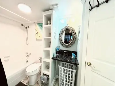 a bathroom with a toilet and a mirror at ON THE BEACH! COUPLES GETAWAY,HONEYMOON SWEET, Perfectly Cozy Beach Front Condo, full kitchen, pool, free parking,CHECK-IN AT DOOR in Panama City Beach