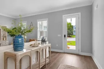 a kitchen with a table with a blue vase on it at Wendell's Place in Inlet Beach