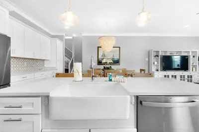 a white kitchen with a large white counter top at Wendell's Place in Inlet Beach