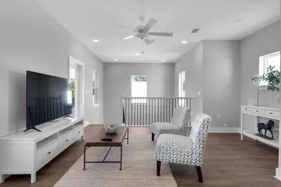 a living room with two chairs and a flat screen tv at Wendell's Place in Inlet Beach