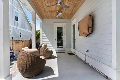 a porch with wicker chairs and a ceiling at Ocean Pearl in Inlet Beach