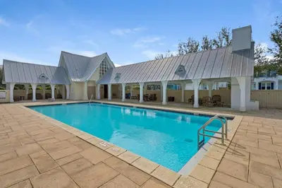 a large swimming pool with a large building at Ocean Pearl in Inlet Beach