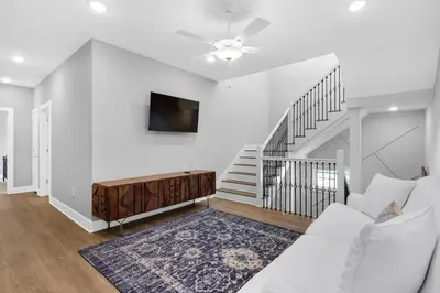 a white living room with a couch and a tv at Ocean Pearl in Inlet Beach