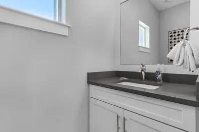 a bathroom with a sink and a mirror at Ocean Pearl in Inlet Beach