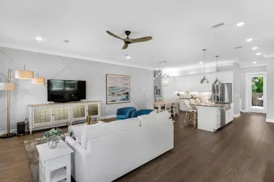 a living room with a white couch and a tv at Ocean Pearl in Inlet Beach