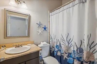 a bathroom with a sink and a toilet and a shower curtain at 30A Beach House - Seagrove Escape by Panhandle Getaways in Seagrove Beach
