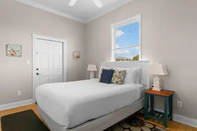 a white bedroom with a bed and a window at 30A Beach House - Seagrove Escape by Panhandle Getaways in Seagrove Beach