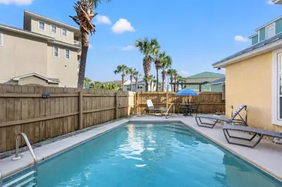 a swimming pool in a yard with a wooden fence at EPIC Beach House with Private Pool, 175 ft to the BEACH, U Gotta See It! in Panama City Beach