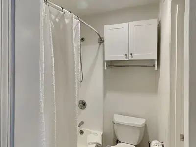 a bathroom with a toilet and a shower curtain at Horizon South #76E in Panama City Beach