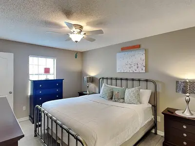 a bedroom with a bed and a ceiling fan at Horizon South #76E in Panama City Beach