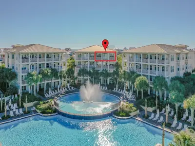 a hot air balloon flies over a fountain in front of buildings at Villas at Seacrest #B401 - Bella Costa in Inlet Beach