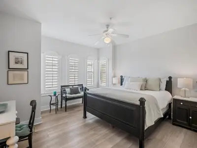 a bedroom with a bed and a ceiling fan at Villas at Seacrest #B401 - Bella Costa in Inlet Beach