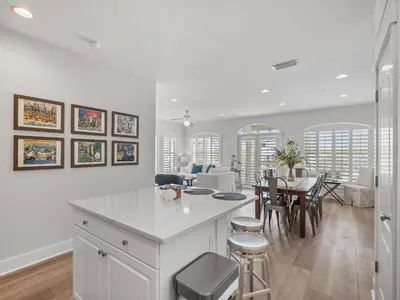 a kitchen and dining room with a table and chairs at Villas at Seacrest #B401 - Bella Costa in Inlet Beach