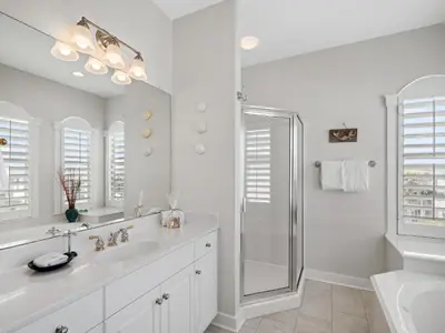 a white bathroom with a shower and a sink at Villas at Seacrest #B401 - Bella Costa in Inlet Beach