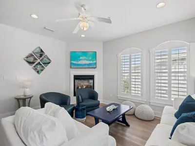 a living room with white furniture and a fireplace at Villas at Seacrest #B401 - Bella Costa in Inlet Beach