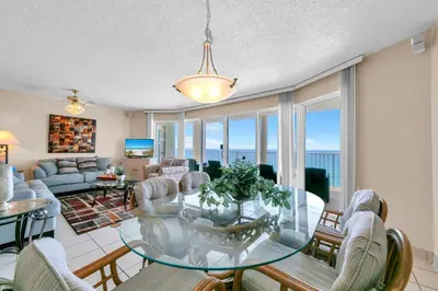 a living room with a glass table and chairs at Long Beach Resort 2-1206 in Panama City Beach