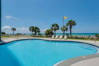 a swimming pool with the ocean in the background at Long Beach Resort 2-1206 in Panama City Beach