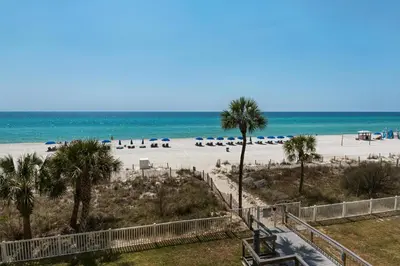 a view of a beach with palm trees and umbrellas at Long Beach Resort 2-1206 in Panama City Beach