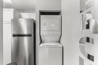 a kitchen with a stainless steel refrigerator and a dishwasher at Sand Castle West #G6 in Panama City Beach