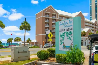 a building with a sign in front of a building at Sand Castle West #G6 in Panama City Beach