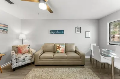 a living room with a couch and a chair at Sand Castle West #G6 in Panama City Beach