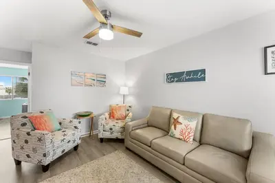 a living room with a couch and two chairs at Sand Castle West #G6 in Panama City Beach
