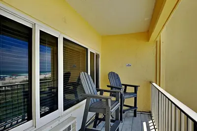 two chairs sitting on the balcony of a house at Continental #221 in Panama City Beach