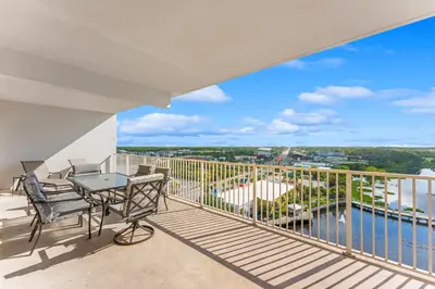 a balcony with a table and chairs and a view of the water at Laketown Wharf #1034 in Panama City Beach