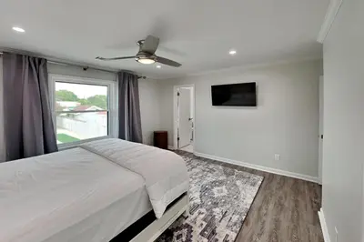 a bedroom with a large bed and a window at Laguna Matata in Panama City Beach