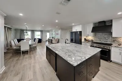 a kitchen with a counter top and a dining room at Laguna Matata in Panama City Beach