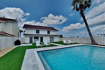 a backyard with a swimming pool and a house at Laguna Matata in Panama City Beach