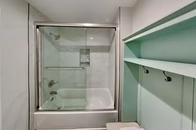 a bathroom with a shower and a bath tub at Laguna Matata in Panama City Beach