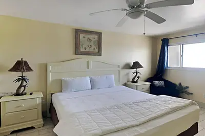 a bedroom with a large white bed with two night stands at Summit Beach Resort #1202 in Panama City Beach