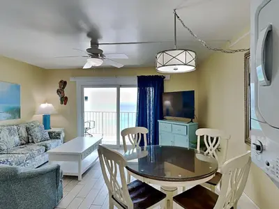 a living room with a table and a couch at Summit Beach Resort #1202 in Panama City Beach