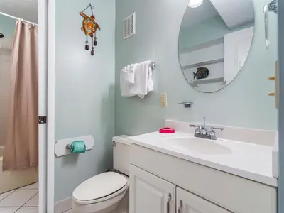 a bathroom with a sink and a toilet and a mirror at Summit Beach Resort 1231 in Panama City Beach