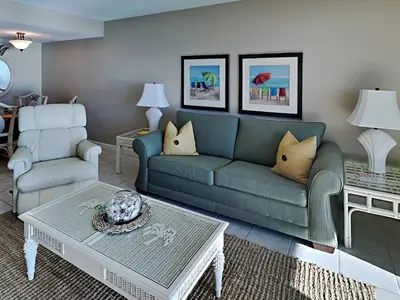 a living room with a couch and a coffee table at Mariner East #306 in Panama City Beach