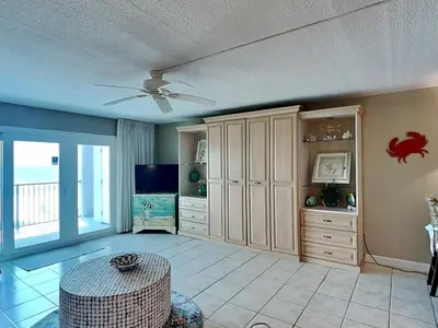 a living room with a ceiling fan and a television at Mariner East #306 in Panama City Beach