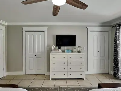 a bedroom with a white dresser and a ceiling fan at Edgewater Villa #909 in Panama City Beach