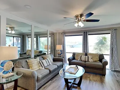 a living room with two couches and a ceiling fan at Edgewater Villa #909 in Panama City Beach